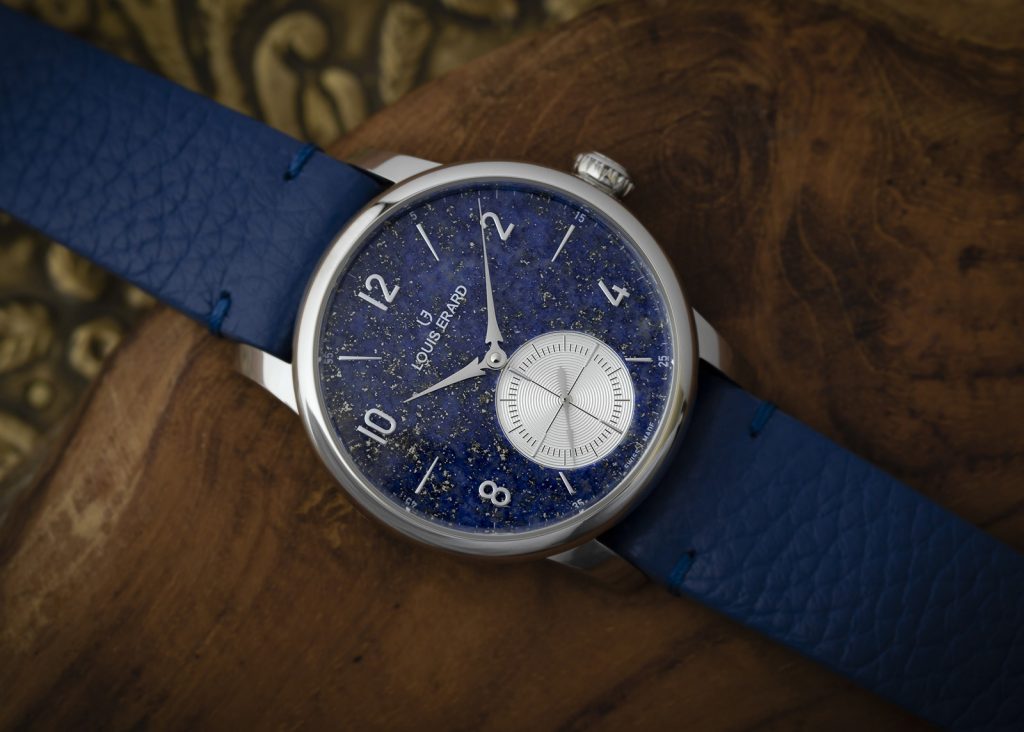 Silver cased watch with sparkling blue stone dial