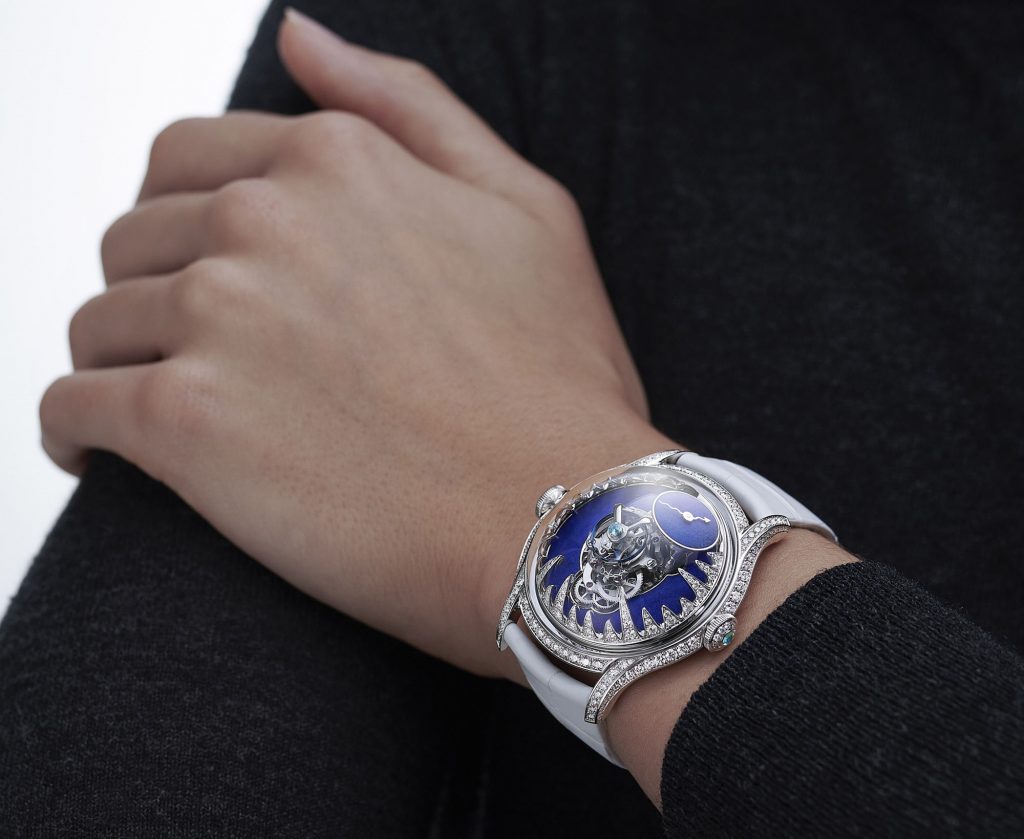 Blue dial watch with diamond setting on a wrist